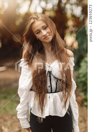 Beautiful adorable girl outdoors in the park enjoying summer day Beautiful adorable girl outdoors in the park enjoying summer day 123659273