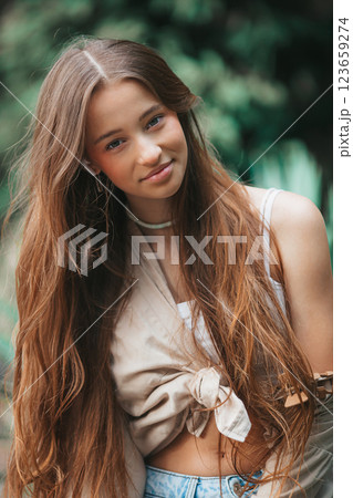 Beautiful adorable girl outdoors in the park enjoying summer day Beautiful adorable girl outdoors in the park enjoying summer day 123659274