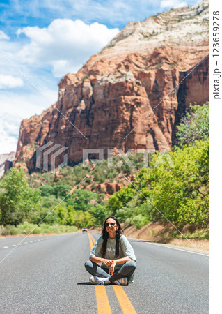 Happy girl on the road in Zion national park. Amazing view of the valley. Happy girl on the road in Zion national park. Amazing view of the valley. 123659278