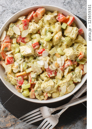 Pesto Chicken Salad with celery, onion, pepper and almond flakes closeup. Vertical top view 123659381
