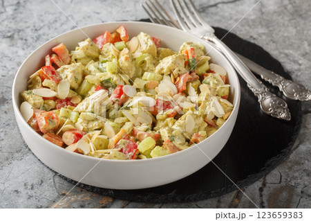 Italian pesto salad with chicken breast, vegetables and nuts close-up in a plate. Horizontal Italian pesto salad with chicken breast, vegetables and nuts close-up in a plate. Horizontal 123659383