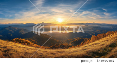 breathtaking sunrise over mountainous landscape, showcasing rolling hills, golden grass, and misty valley below. warm light creates serene and tranquil atmosphere 123659463