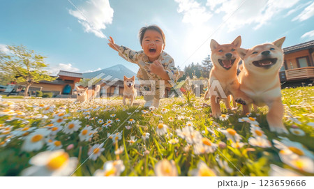 joyful child running through field of daisies with playful dogs, set against scenic backdrop. scene captures happiness and innocence in nature 123659666