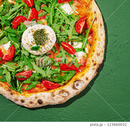 Freshly made pizza topped with arugula and cherry tomatoes Freshly made pizza topped with arugula and cherry tomatoes 123660032