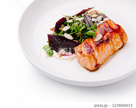 Salmon dish with beetroot and salad on a white plate 123660033