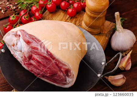 Fresh meat preparation at a rustic kitchen table with herbs Fresh meat preparation at a rustic kitchen table with herbs 123660035