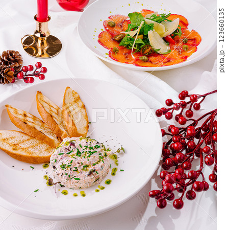 Delicious festive meal featuring appetizers and salad with herbs Delicious festive meal featuring appetizers and salad with herbs 123660135