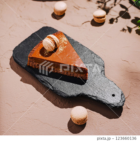 Delicious dessert on slate board with macarons and chocolate cake 123660136