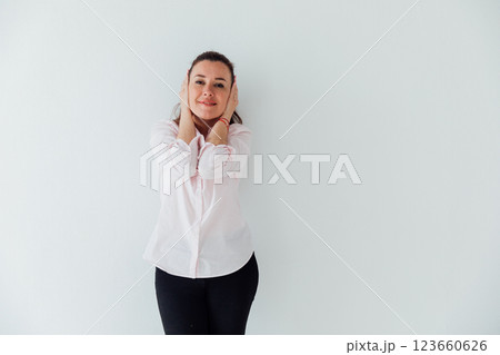 Portrait of a beautiful woman of 40 years old in a business suit near a white wall Portrait of a beautiful woman of 40 years old in a business suit near a white wall 123660626