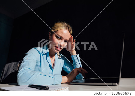 woman blonde at desk with laptop in office online 123660678