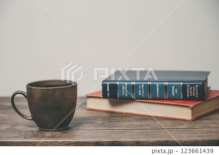 木製の机に置かれたマグカップと本 123661439