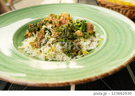 Pilau on Green Plate, Beef Pilaf, Traditional Asian Dish Plov also known as Polow, Pilav, Pallao, Pulao, Palaw 123662030