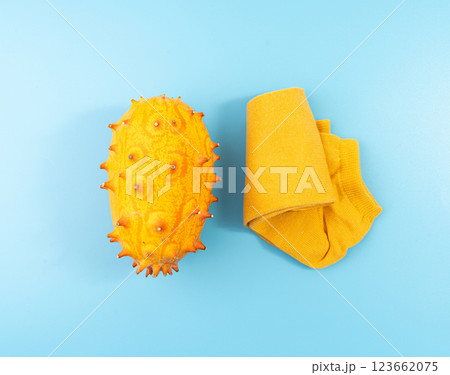 Kiwano on blue, jelly melon, cucumis metuliferus ripe fruit, orange horned melon, african horned cucumber 123662075