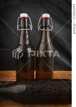 Old beer bottle, brown glass vintage beerbottle, a quality traditional time-tested drink symbol Old beer bottle, brown glass vintage beerbottle, a quality traditional time-tested drink symbol 123662091
