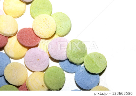 Close up of sugar paper confetti circle spots and colour dots on white background Close up of sugar paper confetti circle spots and colour dots on white background 123663580
