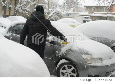 Scraping Ice Off Parked Car 123664028