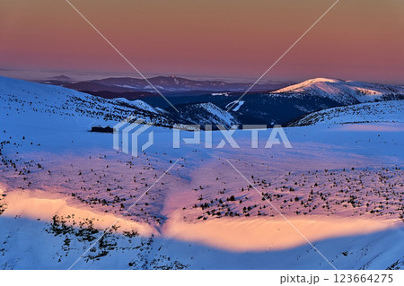 Hiker dawn on frozen peaks, amazing snowy landscape. Mountains aerial view 123664275