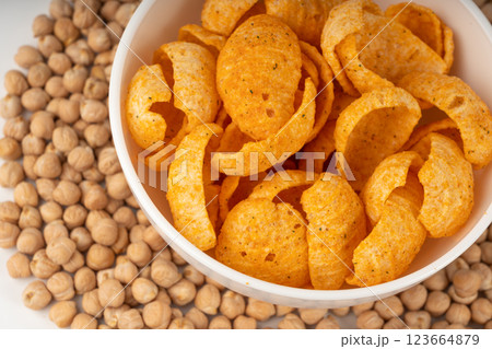 Hummus chickpea chips, chick pea crisps pile, healthy orange snack, fried legume crunchies Hummus chickpea chips, chick pea crisps pile, healthy orange snack, fried legume crunchies 123664879