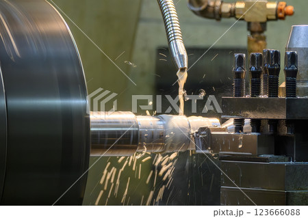 The lathe machine finish cut metal shaft parts with liquid coolant method. 123666088