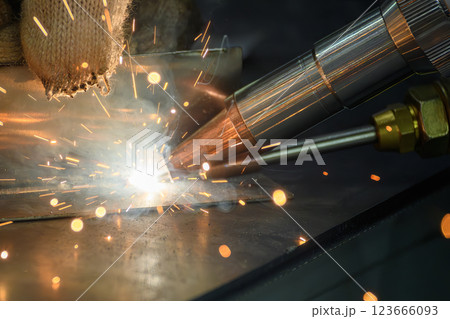 Close up scene the laser welding process by hand held laser welding machine. 123666093