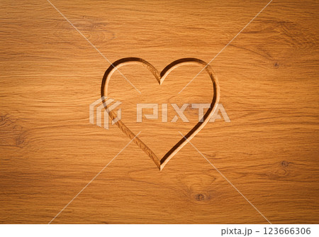 Heart carved in wood 123666306