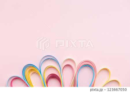 Paper strip curls on pink background 123667050