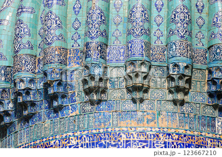 Turquoise Islamic Tile on Blue Dome with arabic calligraphy, geometric and floral patterns on sunny day. Traditional middle eastern architecture with vibrant blue and azure hues on patina 123667210