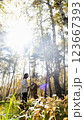 Young woman walking with a dog in an autumn forest 123667393