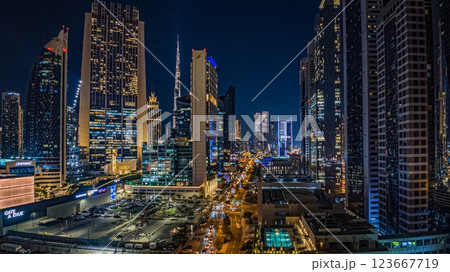 Dubai business district with modern skyscrapers, Burj Khalifa, and highrise buildings at dusk 123667719