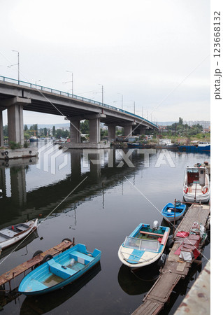 Quiet riverside with small boats below an elevated bridge in Varna Quiet riverside with small boats below an elevated bridge in Varna 123668132