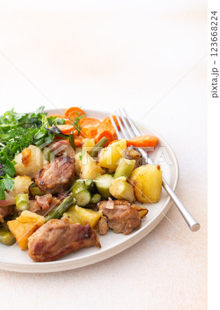 Stewed duck fillet with potatoes and asparagus and radishes, mixed salad of various greens, baked carrots in tahini sauce 123668224