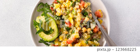 A vibrant vegetarian salad featuring boiled millet, chickpeas, fresh vegetables, and avocado, drizzled with olive oil for a delicious and healthy meal, banner A vibrant vegetarian salad featuring boiled millet, chickpeas, fresh vegetables, and avocado, drizzled with olive oil for a delicious and healthy meal, banner 123668225