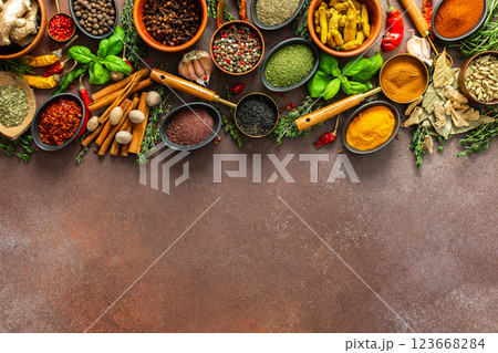A vibrant collection of fresh, fragrant spices and herbs arranged in a colorful display on a rich brown backdrop, showcasing their natural and aromatic beauty A vibrant collection of fresh, fragrant spices and herbs arranged in a colorful display on a rich brown backdrop, showcasing their natural and aromatic beauty 123668284