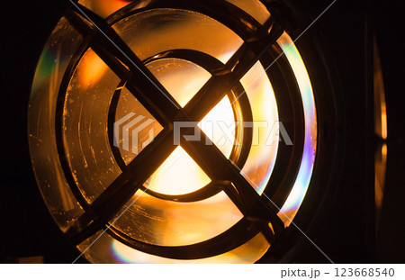 An artistic close-up photograph of a bright illuminated Fresnel lens 123668540
