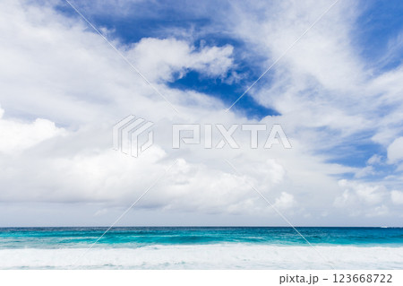 Peaceful ocean waters meet a vibrant blue sky. Mahe, Seychelles Peaceful ocean waters meet a vibrant blue sky. Mahe, Seychelles 123668722