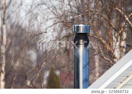 A metallic chimney with black smoke top 123668732