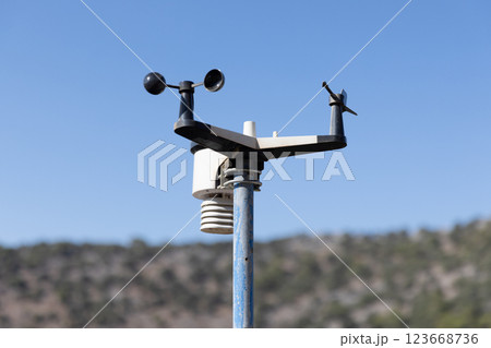 A weather measurement device positioned outdoors captures data 123668736