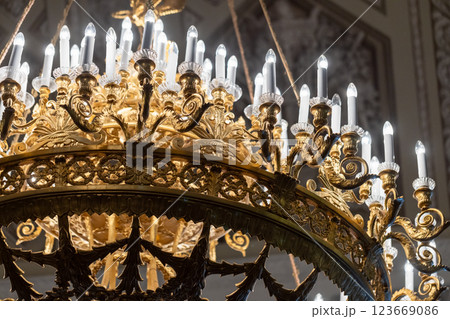 Golden chandelier adorned with intricate designs Golden chandelier adorned with intricate designs 123669086