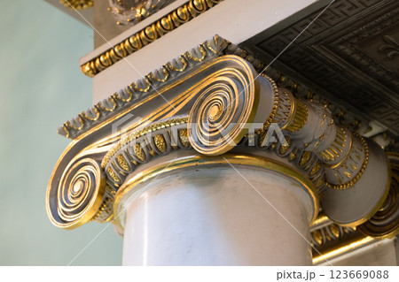 Decorative features of an Ionic column showcasing intricate gold patterns 123669088