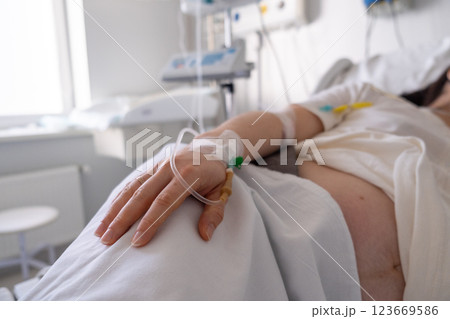 Patient in Hospital Bed with IV Drip Patient in Hospital Bed with IV Drip 123669586