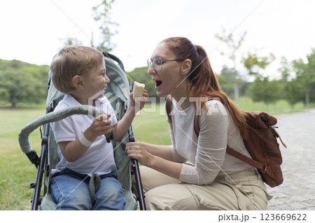 Happy family sharing food while having fun in the park 123669622