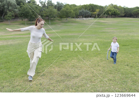 Mother and son playing airplane in the park Mother and son playing airplane in the park 123669644