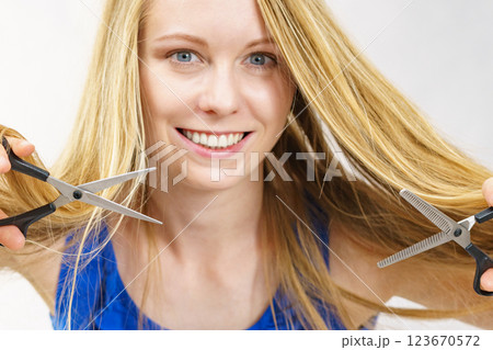 Girl with scissors for haircutting 123670572