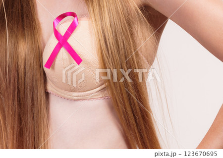 Woman chest in bra, pink cancer ribbon Woman chest in bra, pink cancer ribbon 123670695