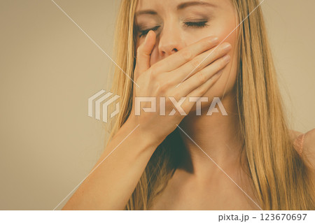 Shocked woman covering her mouth with hand 123670697