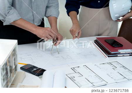 Architect and engineer are discussing and viewing and editing plans Architect and engineer are discussing and viewing and editing plans 123671786