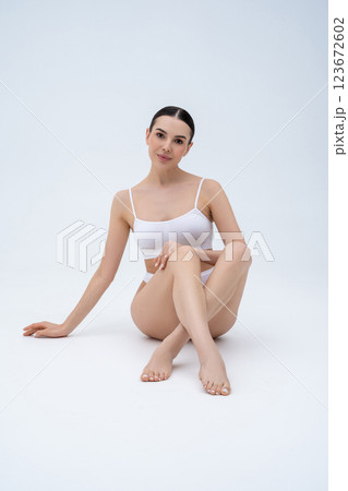 Slim long-legged beautiful woman on a white background Slim long-legged beautiful woman on a white background 123672602