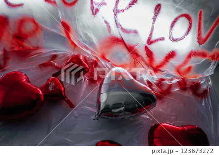 foil heart shaped balloons on white floor. photo zone for love day in photo studio 123673272