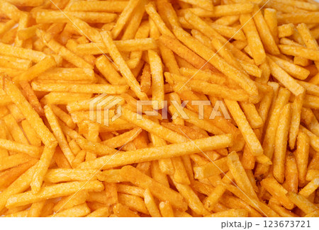 Fried chips sticks texture background, finger potato ketchup flavored chips pattern, shoestring fries 123673721