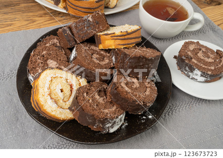 Chocolate Swiss Roll, Round Sponge Cake, Sliced Rolled Vanilla Biscuit with Cocoa Cream Filling Chocolate Swiss Roll, Round Sponge Cake, Sliced Rolled Vanilla Biscuit with Cocoa Cream Filling 123673723